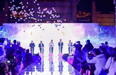 Performers on the illuminated event stage