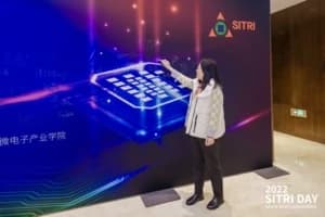 Visitor beside a SITRI technology display wall