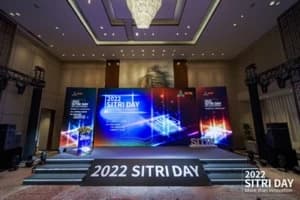 SITRI Day 2022 conference stage with branded digital screens and an audience seating area